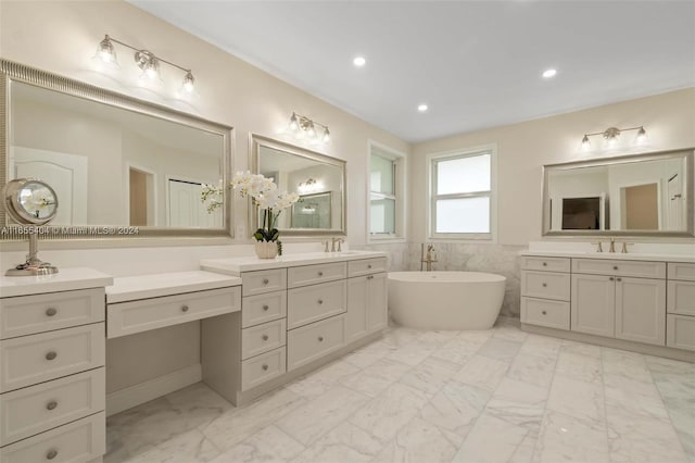 bathroom with vanity, a bath, and tile walls