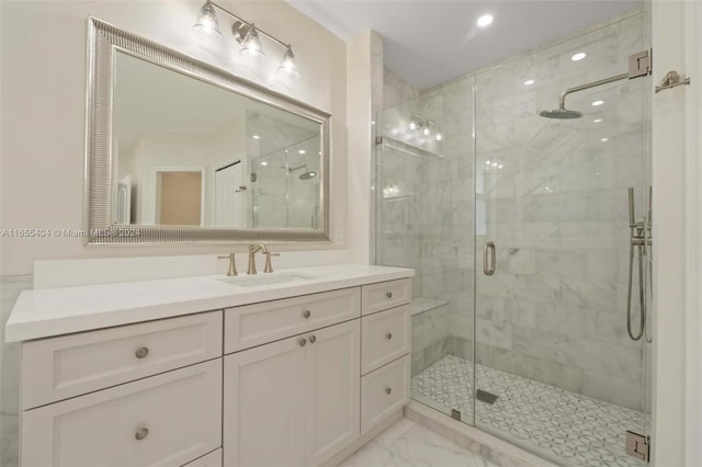 bathroom with vanity and a shower with door