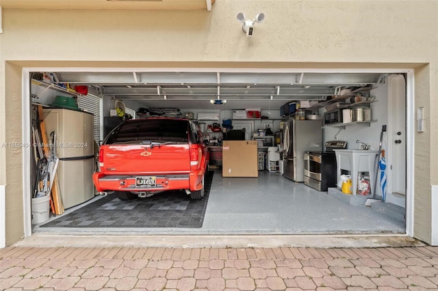 garage featuring stainless steel fridge and sink