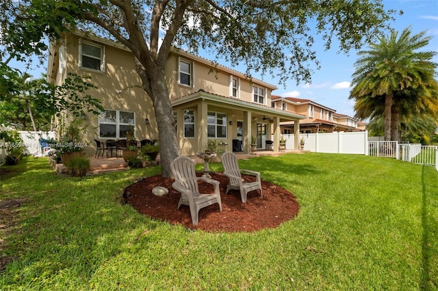 rear view of house with a yard and a patio