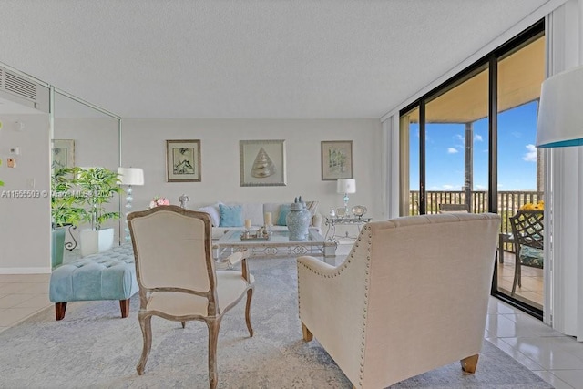 tiled living room with a textured ceiling and expansive windows