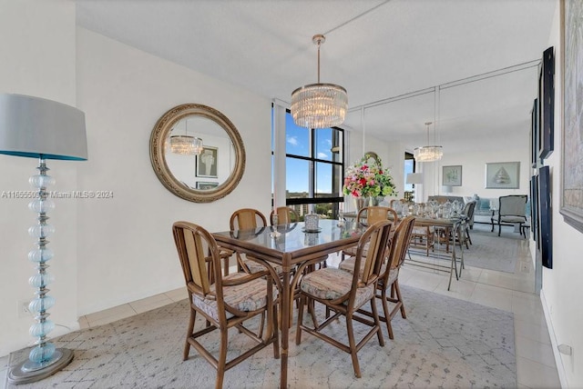 tiled dining room with a chandelier