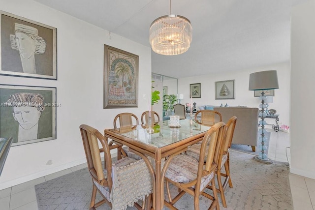 tiled dining area featuring a notable chandelier