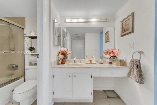 full bathroom featuring shower / bath combination with glass door, tile patterned flooring, toilet, and vanity