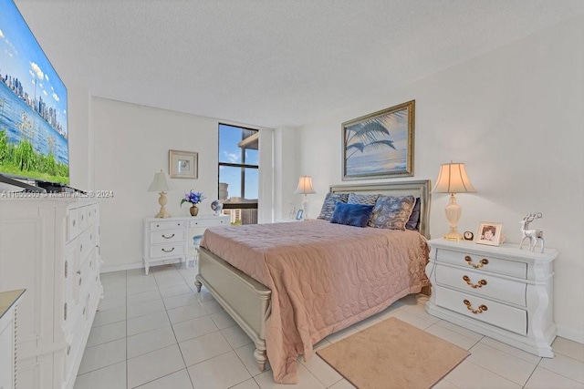 tiled bedroom with a textured ceiling