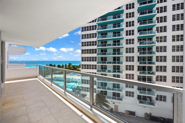 balcony featuring a water view and central air condition unit