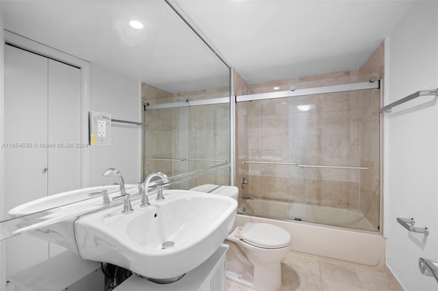 full bathroom with vanity, toilet, and bath / shower combo with glass door