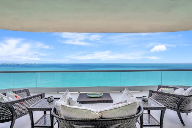 balcony with a water view and an outdoor living space