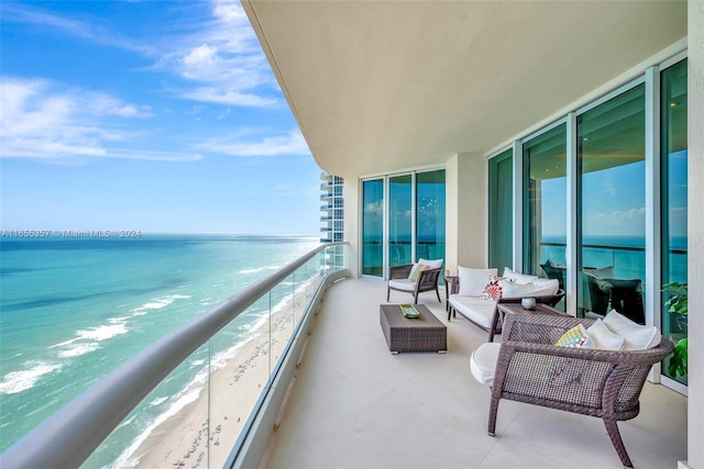 balcony with a water view, a beach view, and outdoor lounge area