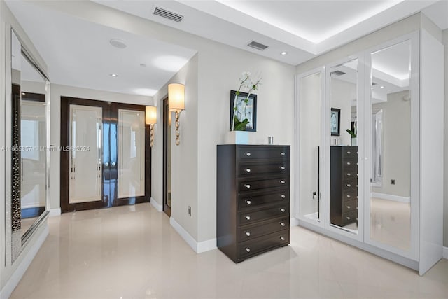 hall with light tile patterned floors and french doors