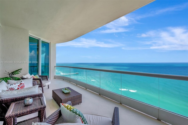 balcony with a water view and an outdoor hangout area