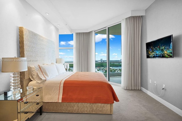 bedroom featuring floor to ceiling windows, access to exterior, and carpet flooring