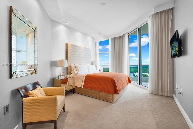 carpeted bedroom featuring floor to ceiling windows and access to exterior