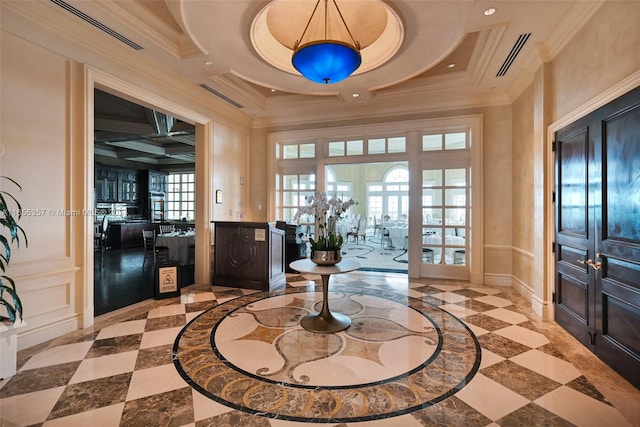 foyer featuring french doors, ornamental molding, and coffered ceiling