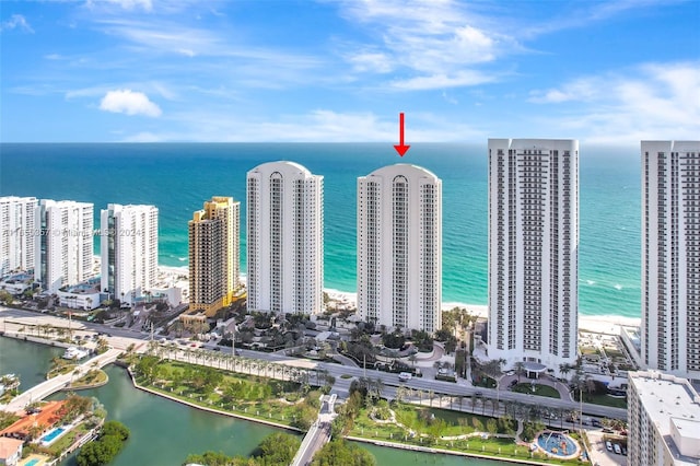 drone / aerial view featuring a water view and a beach view