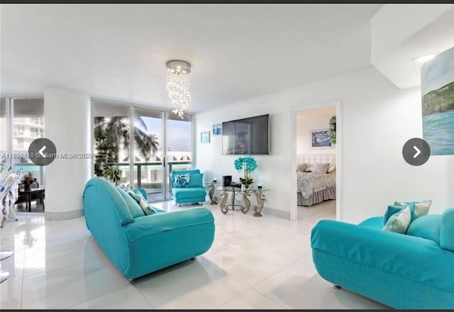 tiled living room with a notable chandelier