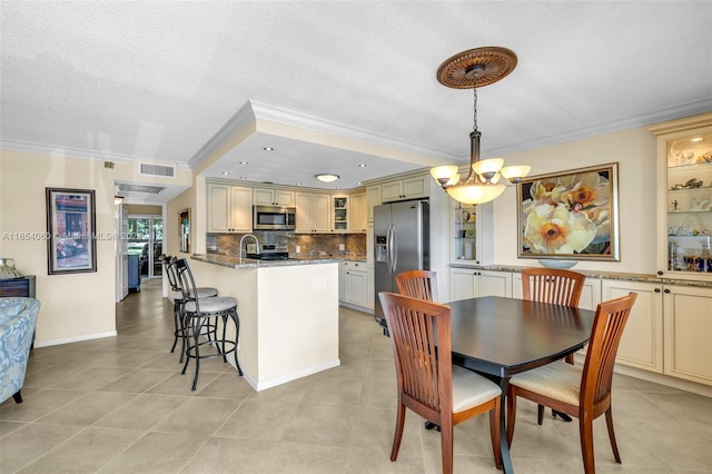 tiled dining space featuring crown molding, a textured ceiling, and a notable chandelier