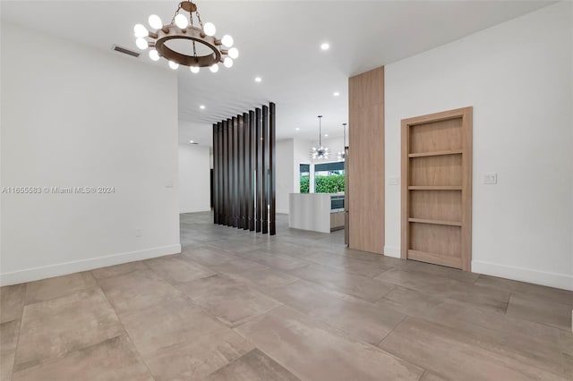 unfurnished living room with a notable chandelier