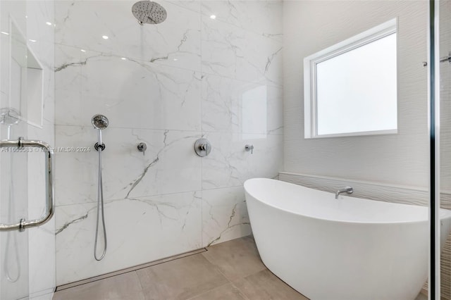 bathroom featuring tile patterned flooring and shower with separate bathtub