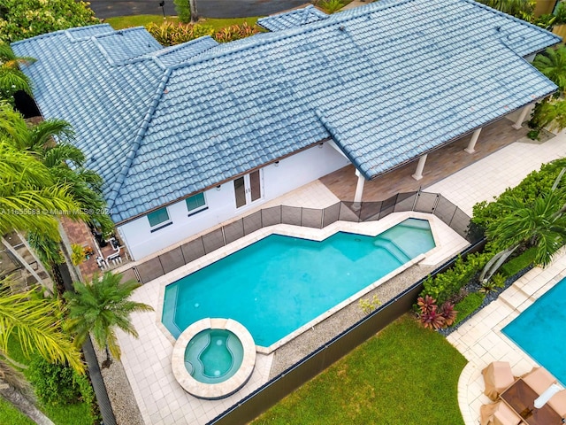 view of swimming pool with a patio area and an in ground hot tub