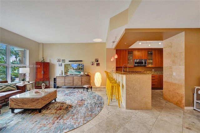 living room featuring light tile patterned flooring and sink