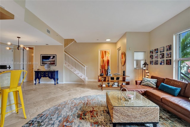 living room featuring an inviting chandelier and light tile patterned floors