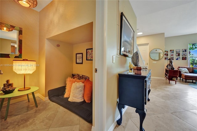 hall featuring light tile patterned flooring