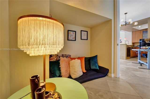 interior space with light tile patterned flooring and an inviting chandelier