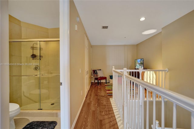 corridor with hardwood / wood-style floors