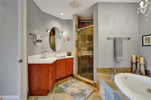 bathroom with tile patterned flooring, separate shower and tub, a chandelier, and vanity