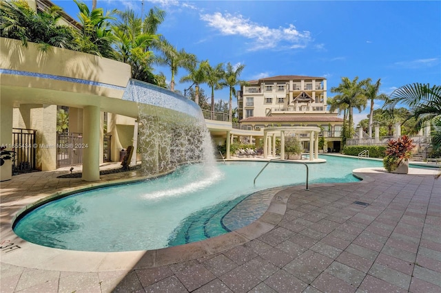 view of swimming pool with a patio and pool water feature