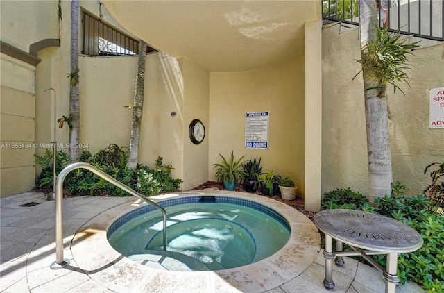 view of pool with a community hot tub and a patio area