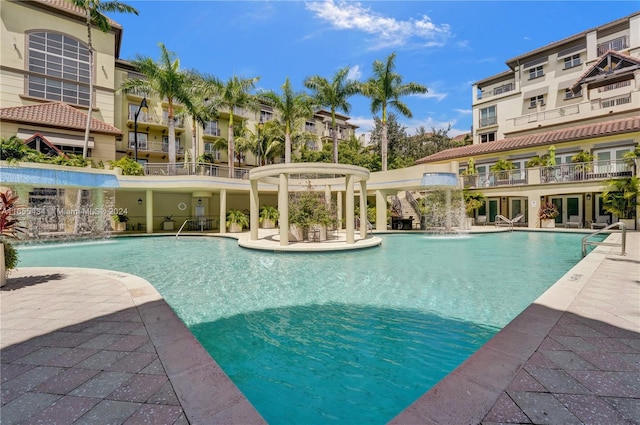 view of swimming pool with pool water feature