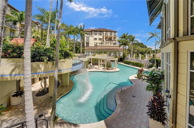 view of swimming pool featuring pool water feature and a patio area