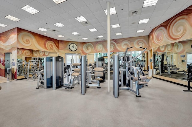 gym with plenty of natural light and a drop ceiling