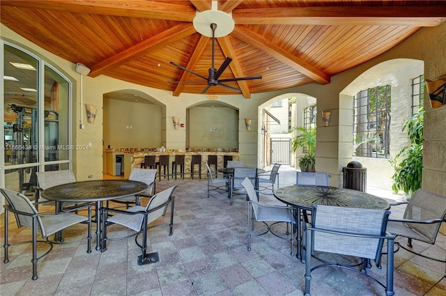 view of patio featuring ceiling fan and exterior bar