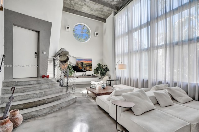 interior space with a towering ceiling and concrete flooring