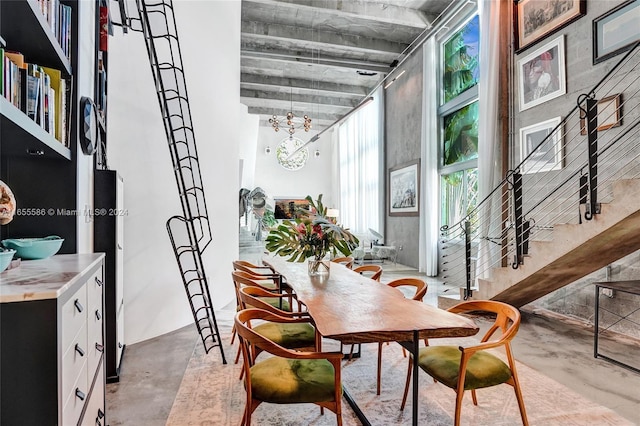 dining area featuring concrete floors and an inviting chandelier