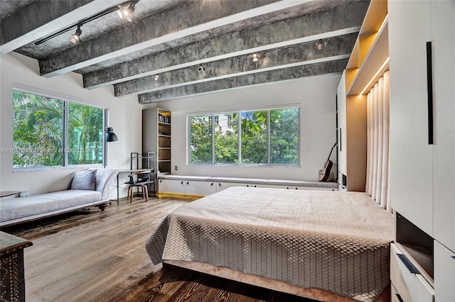 bedroom featuring wood-type flooring and beam ceiling