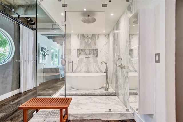 bathroom featuring a wealth of natural light, tile walls, and separate shower and tub