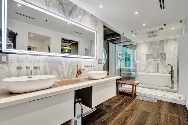 bathroom featuring vanity, hardwood / wood-style floors, and shower with separate bathtub