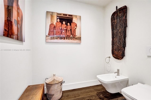 bathroom featuring a bidet, toilet, and hardwood / wood-style flooring