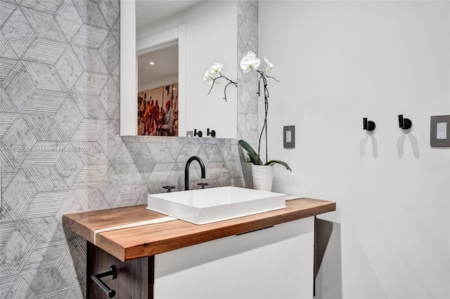 bathroom with vanity and tile walls