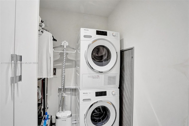 washroom featuring stacked washer and clothes dryer