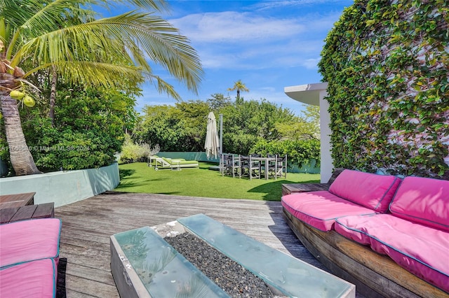 deck featuring an outdoor living space and a yard