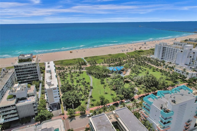 birds eye view of property with a beach view and a water view