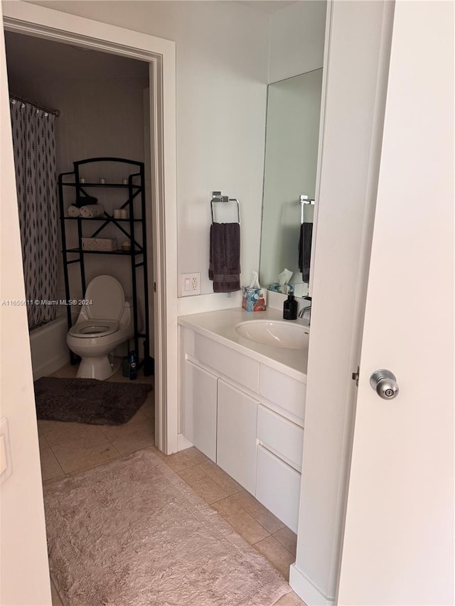 bathroom featuring curtained shower, tile patterned flooring, toilet, and vanity