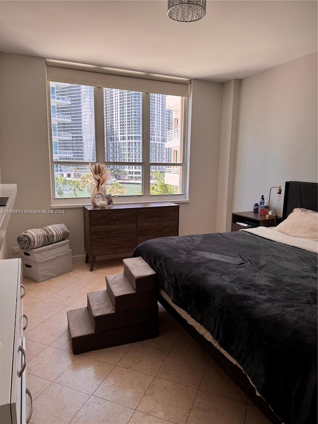 tiled bedroom featuring multiple windows