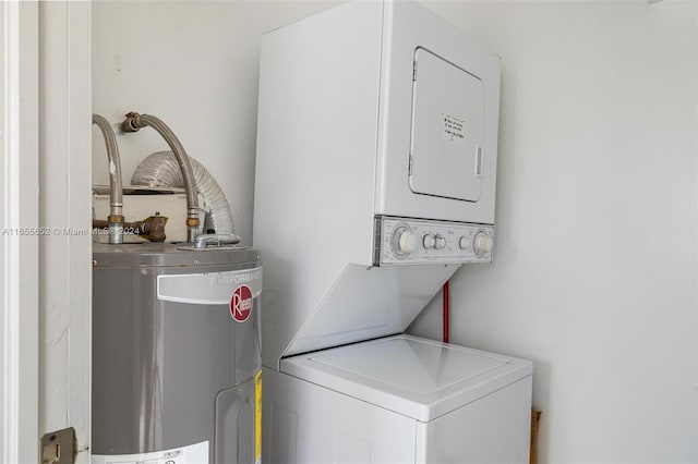 washroom featuring stacked washer / dryer and water heater