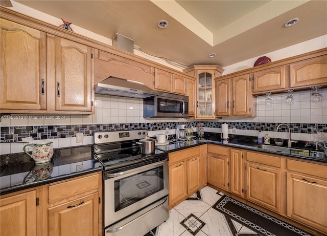 kitchen with appliances with stainless steel finishes, backsplash, and sink